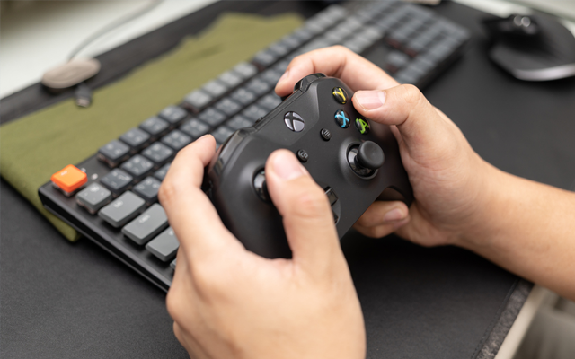 A pair of hands using a video game controller